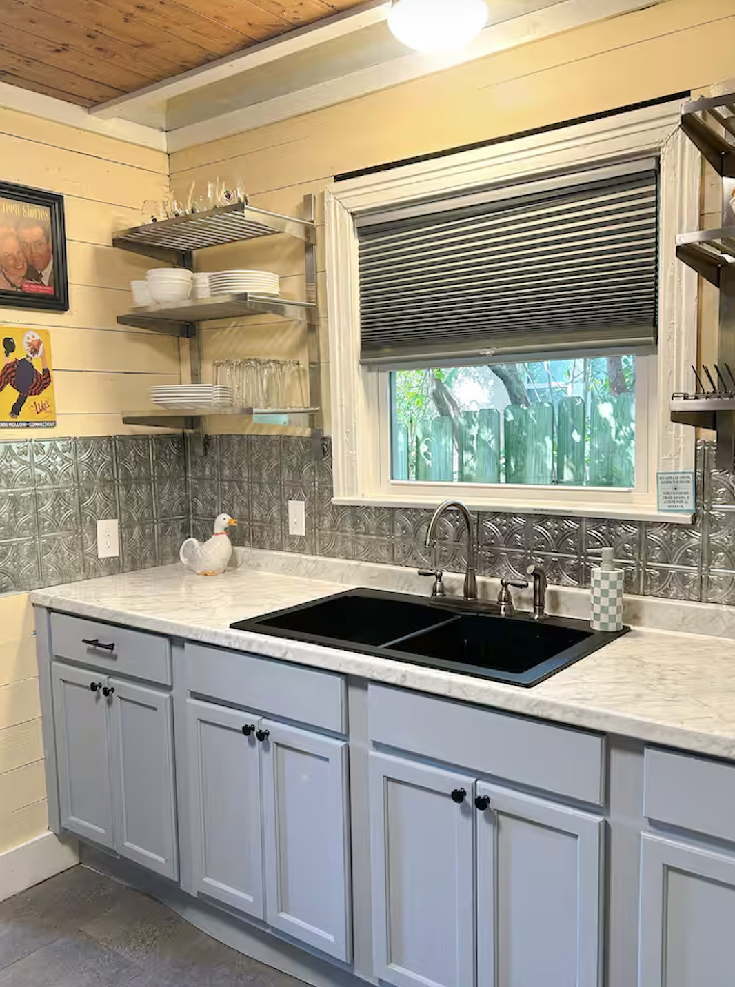 Kitchen with marble counters and tin backsplash